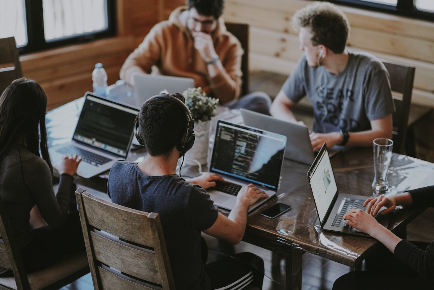 Ryzera team collaborating around a laptop in a modern workspace